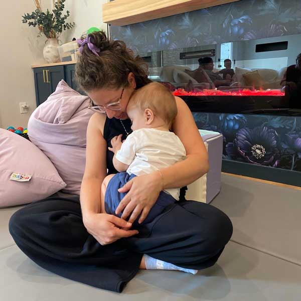 Miss Lee in private guidance session snuggling baby
